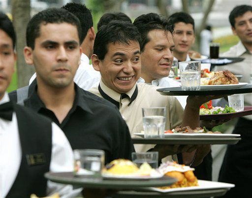 The waiter brings food to another table